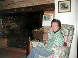 Image of Judy Maynard in front of fireplace